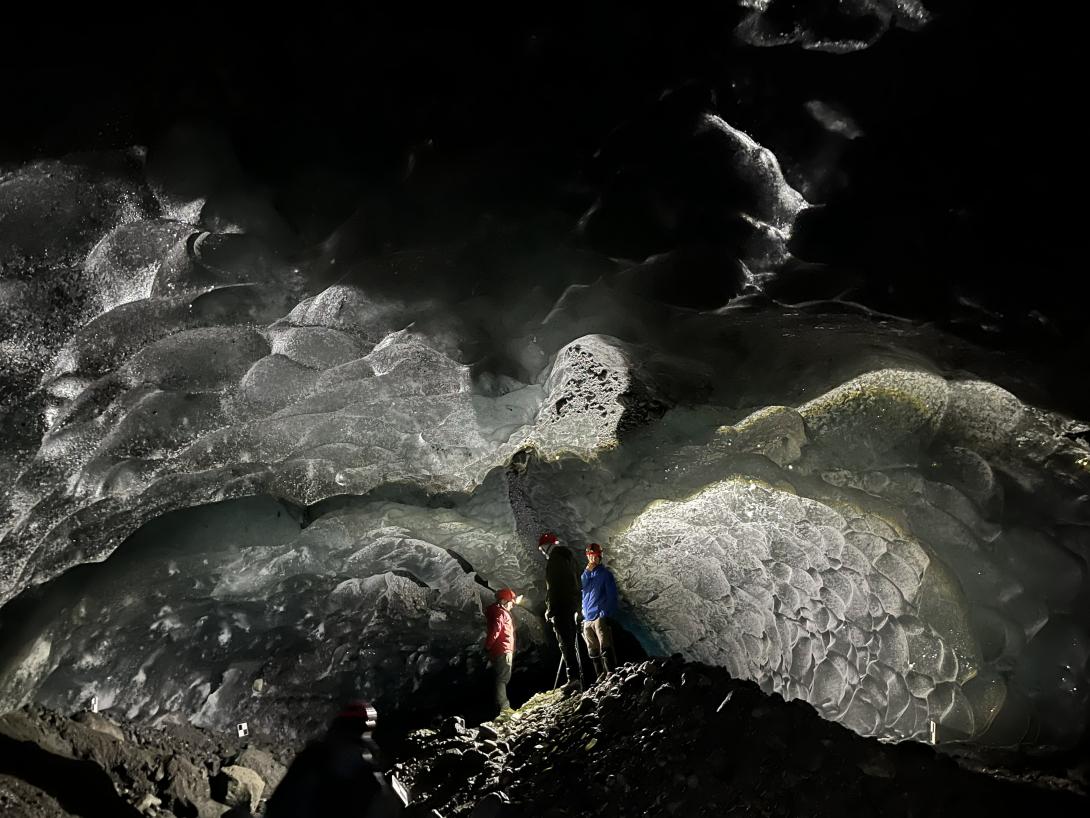 Researchers stand inside a glacier cave at Root Glacier in Wrangell-St. Elias National Park. Photo by Andreas Pflitsch.