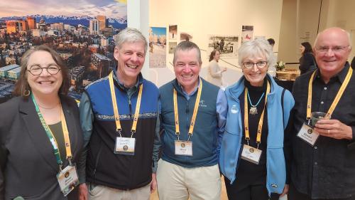 Five people pose for a photo