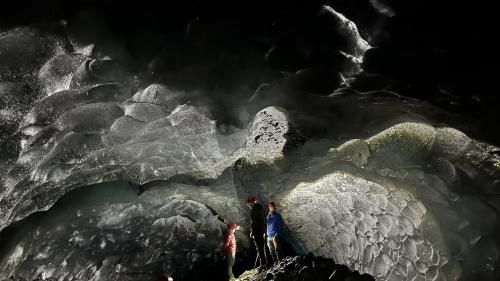 Researchers stand inside a glacier cave at Root Glacier in Wrangell-St. Elias National Park. Photo by Andreas Pflitsch.